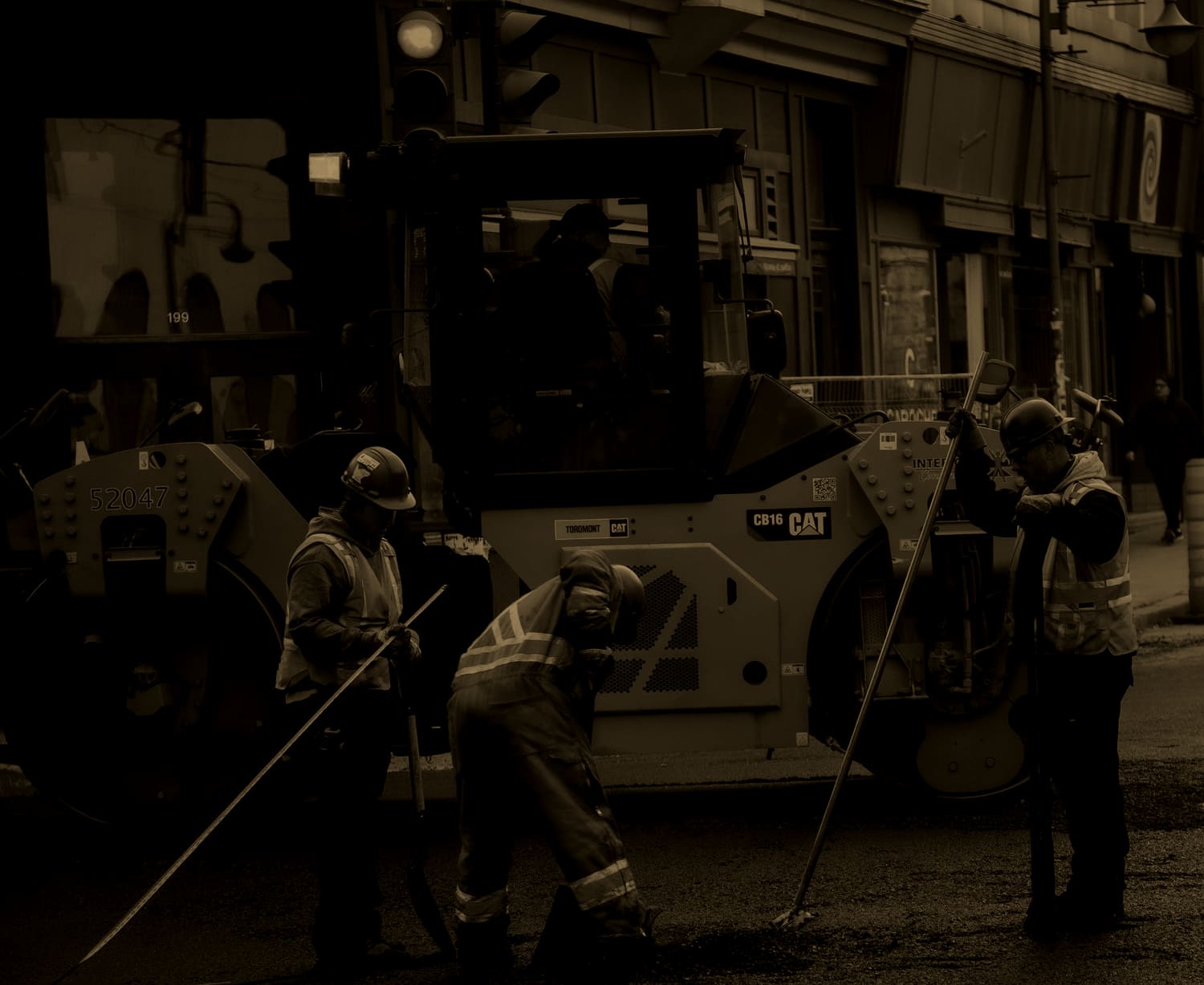 Road crew in hard hats and hi-vis vests working a Québec City street