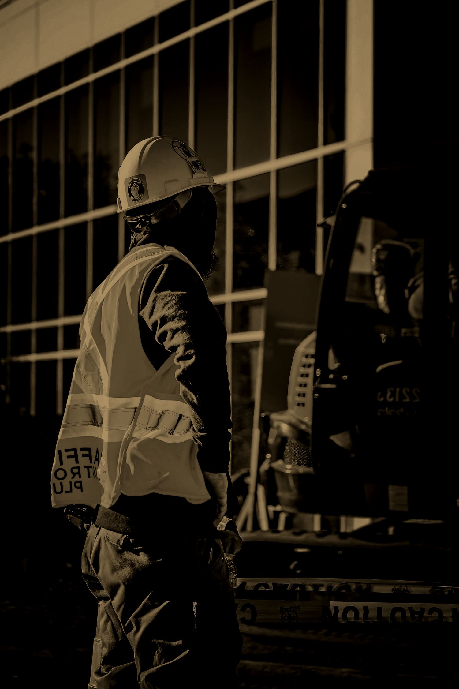 Traffic-control worker in hi-vis vest and safety glasses at an Ontario job site